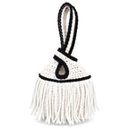 Handmade crochet mini swing bag in Gardenia white with flowing fringe, Onyx black trim and a loop-through wristlet handle.
