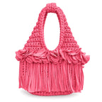 Handmade hot pink coral crochet mini bag with sculptural floral trim, flowing fringe and a braided handle.