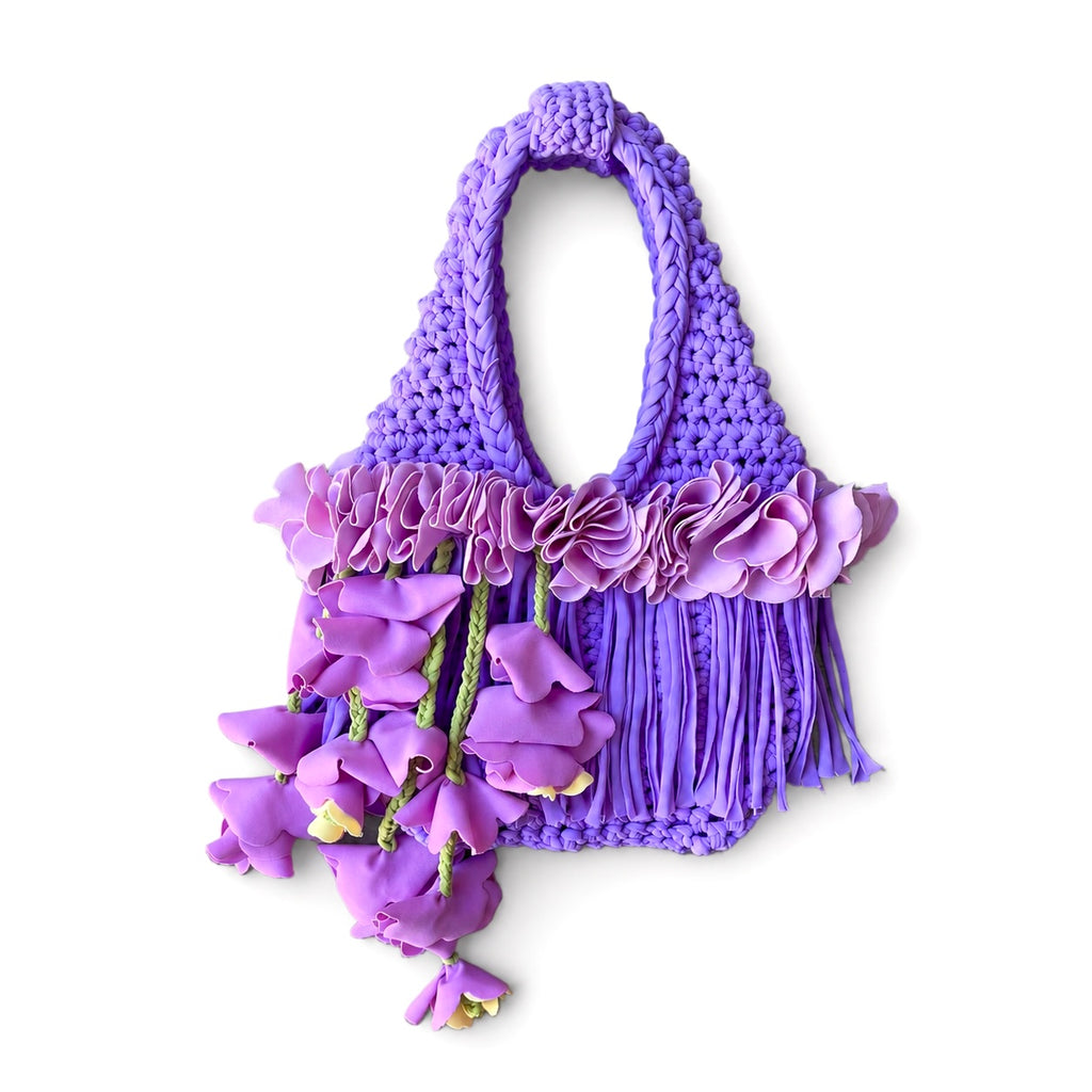 Handmade lilac purple crochet whimsy mini bag with cascading floral fringe and braided orchid petal bells.