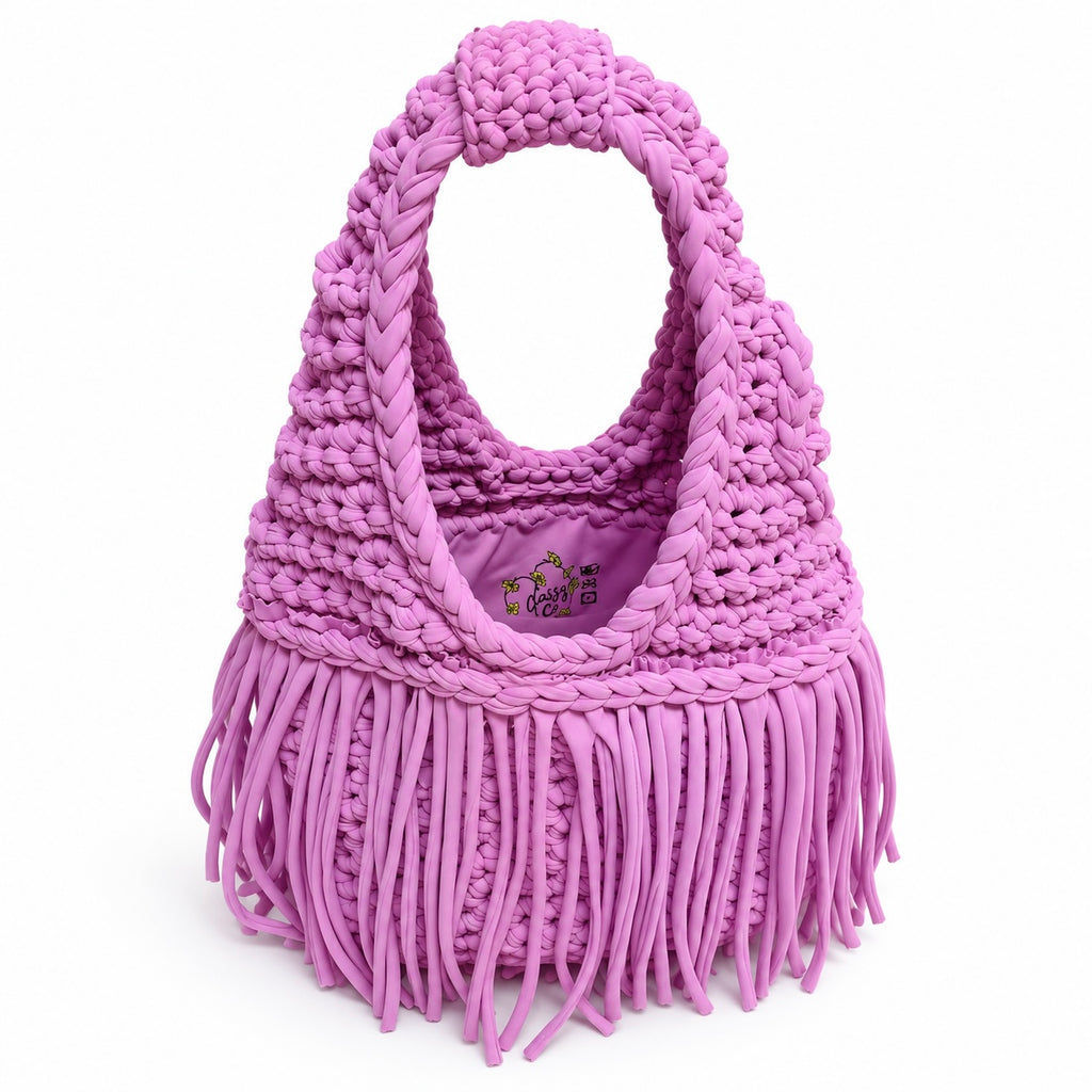 Handmade Orchid pink purple crochet fringe mini bag with flowing fringe and a braided handle.