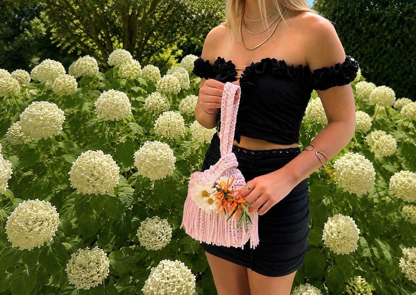 Handmade pink crochet bag and black floral matching set designed by Daisy Chain. 