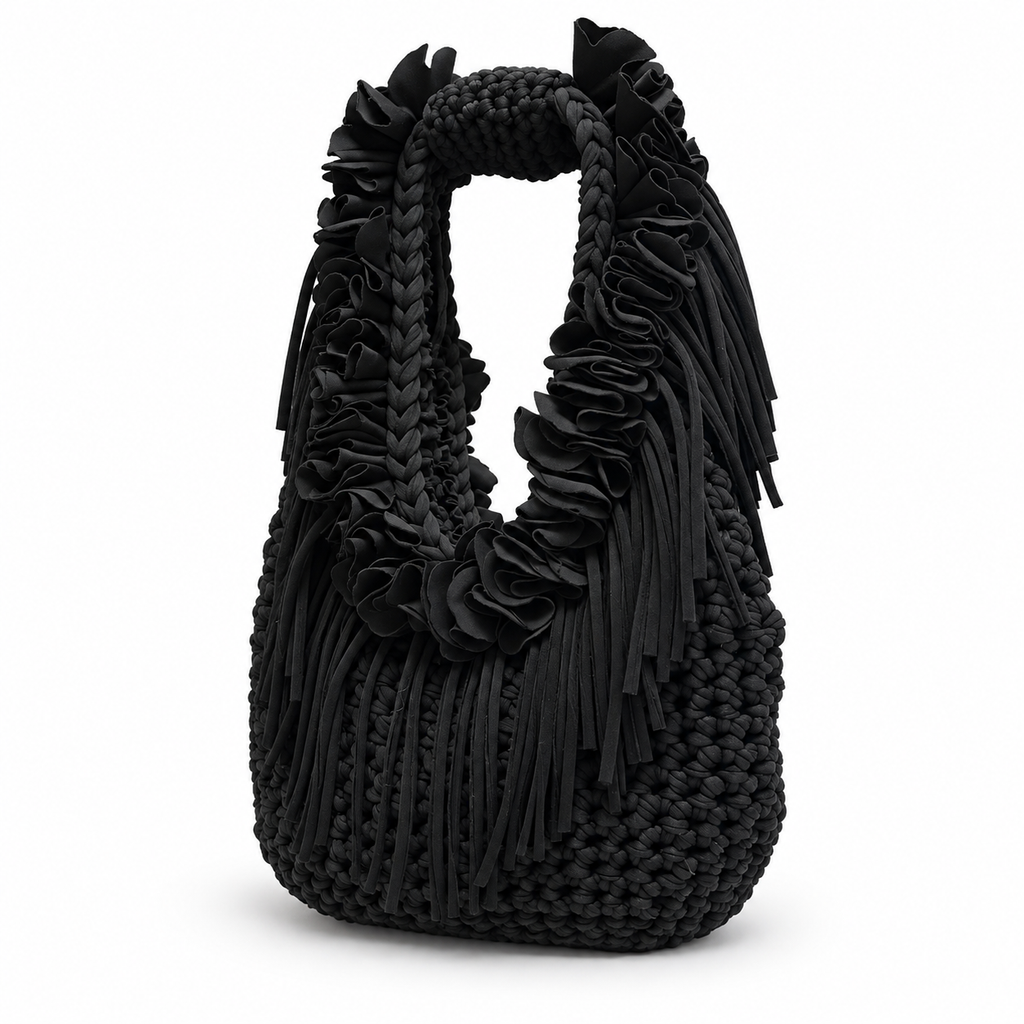 Onyx black hand-crocheted Flower Lei Mini bag with cascading floral ruffles and fringe, featuring a braided handle and sculptural mini silhouette.