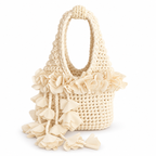 Handmade crochet petal bell mini bag in magnolia cream, with braided handle and cascading petal trim. 