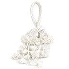 Handmade crochet petal bell mini swing bag in gardenia white with a loop through wristlet handle and cascading petal trim. 