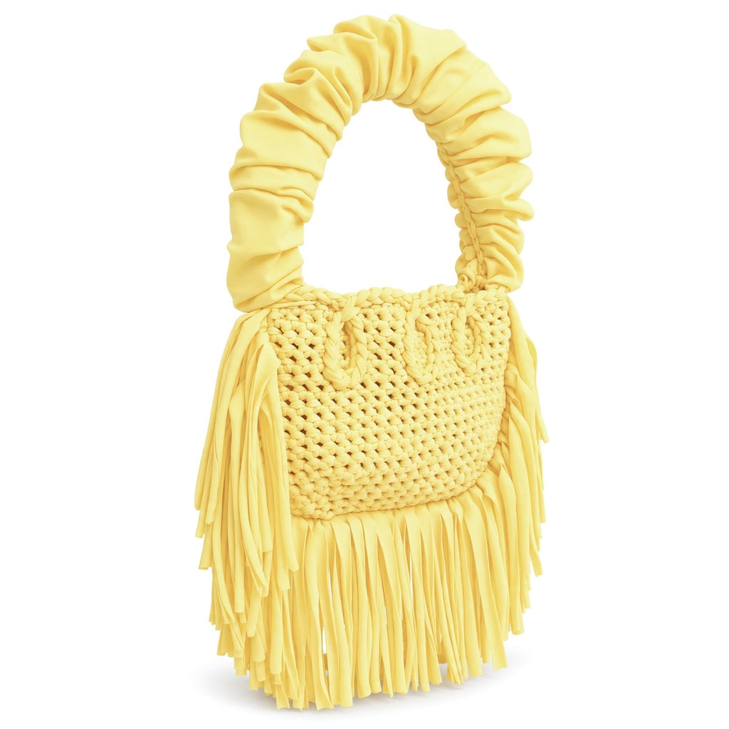 Daffodil yellow handmade crochet Cha Cha Mini bag featuring a crescent-shaped body, braided loop detailing, ruched scrunchie handle and flowing fringe. 