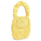 Daffodil yellow handmade crochet Cha Cha Mini bag featuring a crescent-shaped body, braided loop detailing, ruched scrunchie handle and flowing fringe. 