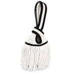 Handmade crochet mini swing bag in Gardenia white with flowing fringe, Onyx black trim and a loop-through wristlet handle.