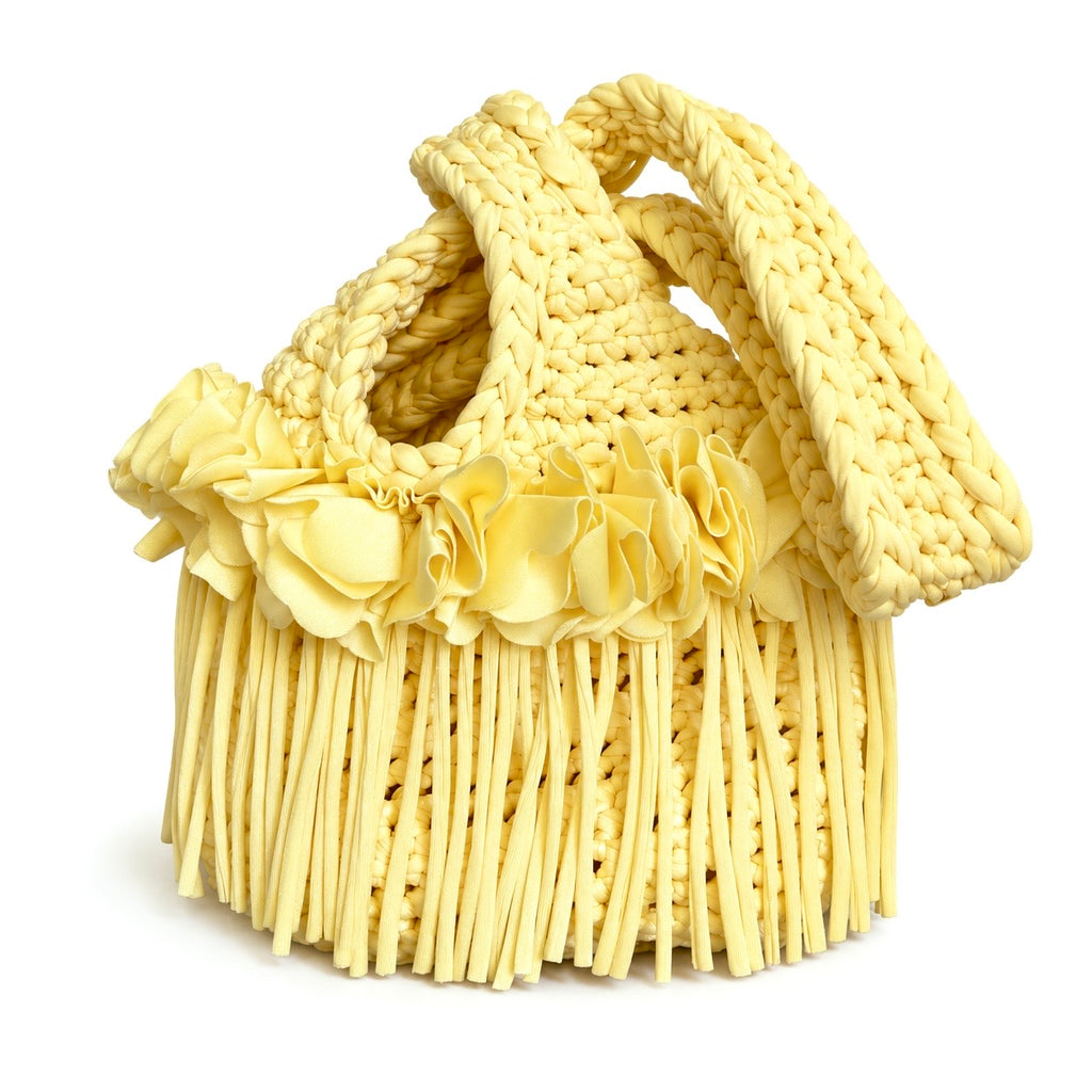 Handmade crochet mini swing bag in Daffodil light yellow with flower fringe and a loop-through wristlet handle.