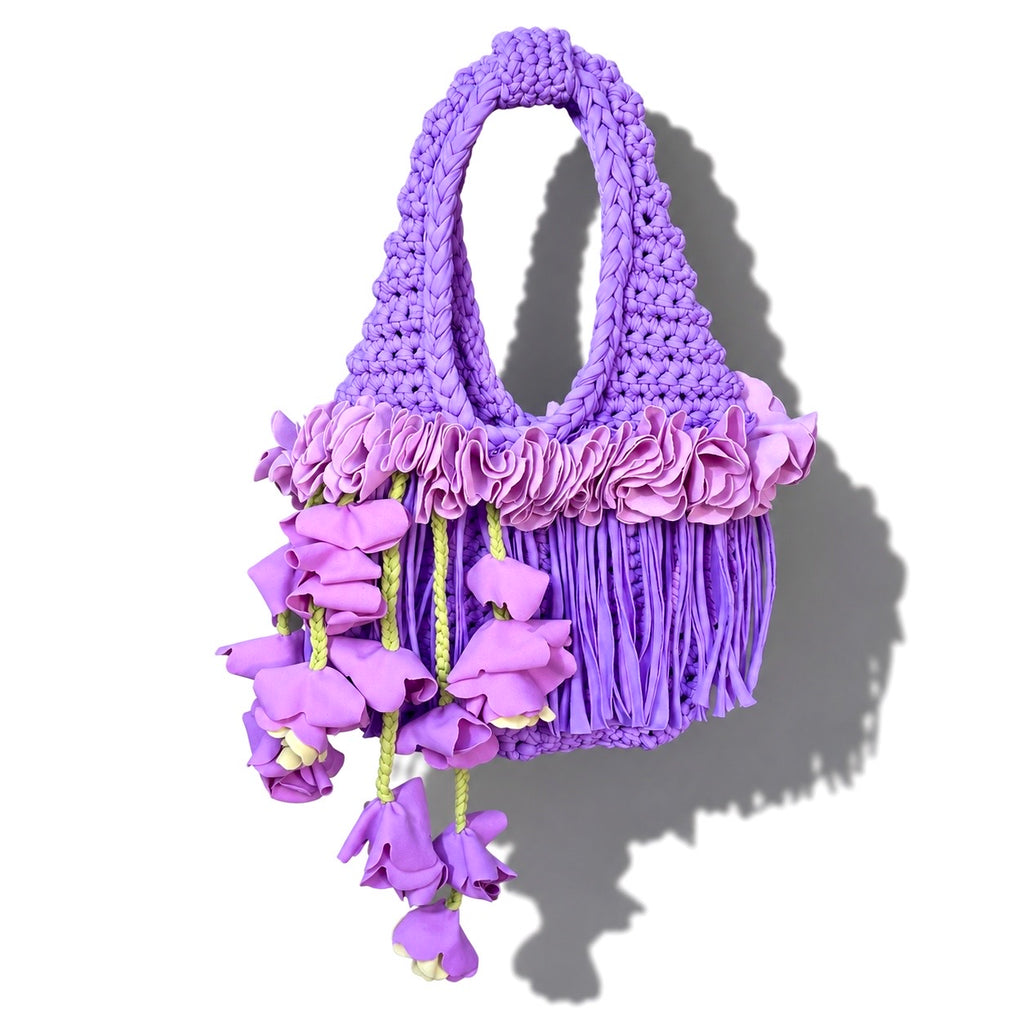 Handmade lilac purple crochet whimsy mini bag with cascading floral fringe and braided orchid petal bells.