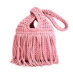 Handmade crochet mini swing bag in Petal pink with flowing fringe and a loop-through wristlet handle.
