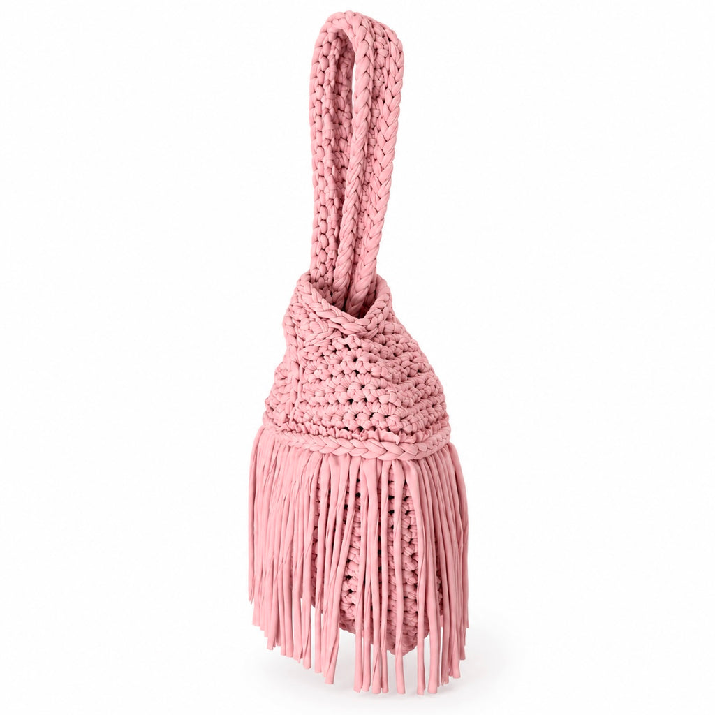 Handmade crochet mini swing bag in Petal pink with flowing fringe and a loop-through wristlet handle.
