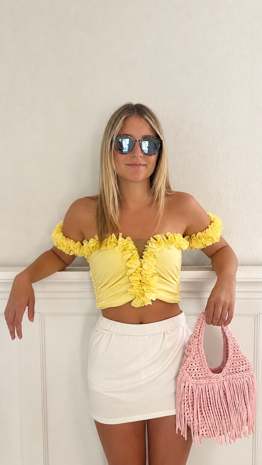 Handmade Petal pink crochet fringe mini bag and daffodil yellow flower lei top, made with stretch nylon/spandex. 