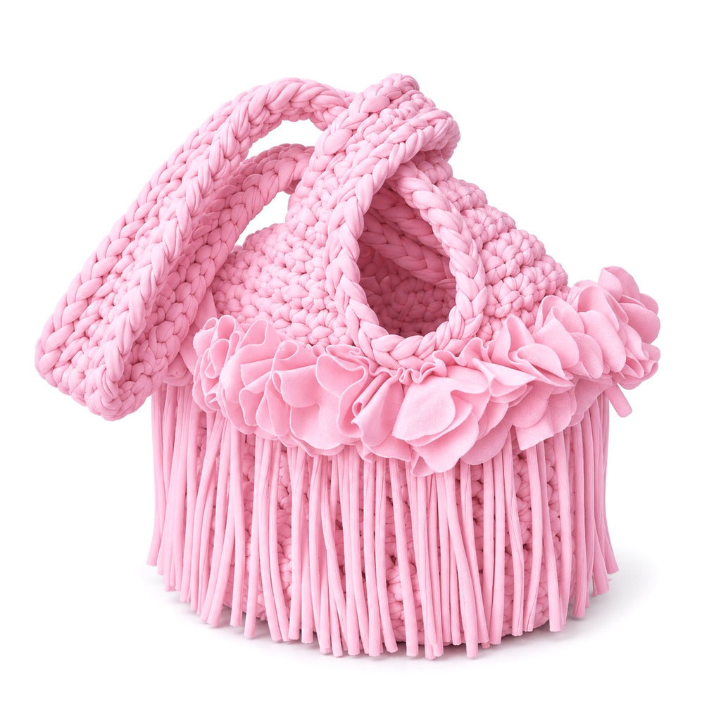 Handmade crochet mini swing bag in Petal pink with flower fringe and a loop-through wristlet handle.