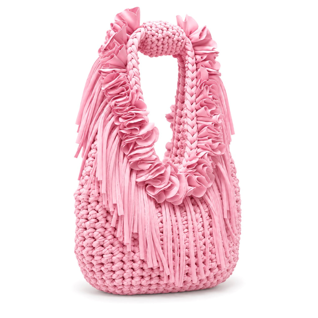 Petal pink hand-crocheted Flower Lei Mini bag with cascading floral ruffles and fringe, featuring a braided handle and sculptural mini silhouette.
