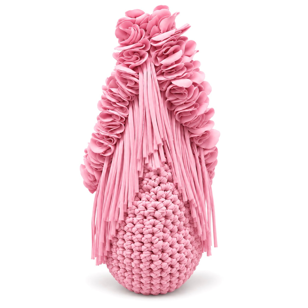 Petal pink hand-crocheted Flower Lei Mini bag with cascading floral ruffles and fringe, featuring a braided handle and sculptural mini silhouette.