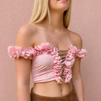 Petal pink off-the-shoulder flower lei tube top with floral trim and hand-crocheted lace-up center detail.