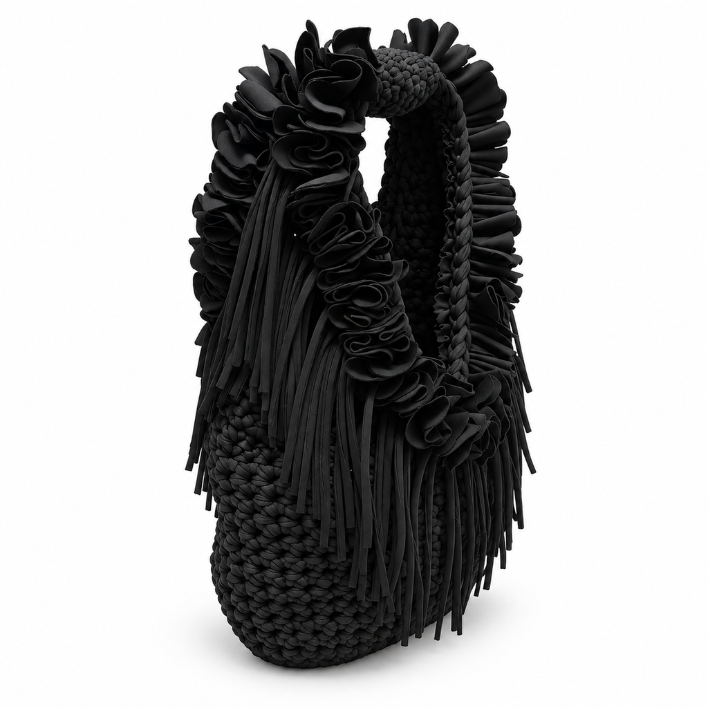 Onyx black hand-crocheted Flower Lei Mini bag with cascading floral ruffles and fringe, featuring a braided handle and sculptural mini silhouette.