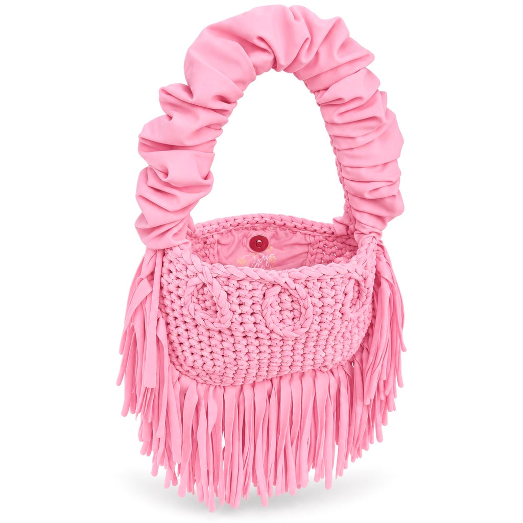Petal pink handmade crochet Cha Cha Mini bag featuring a crescent-shaped body, braided loop detailing, ruched scrunchie handle and flowing fringe. 