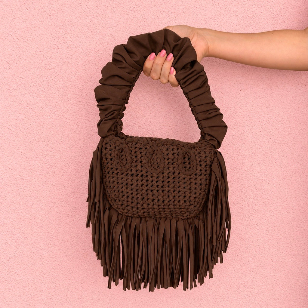 Coconut Shell brown handmade crochet Cha Cha Mini bag featuring a crescent-shaped body, braided loop detailing, ruched scrunchie handle and flowing fringe. 