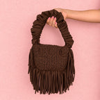 Coconut Shell brown handmade crochet Cha Cha Mini bag featuring a crescent-shaped body, braided loop detailing, ruched scrunchie handle and flowing fringe. 