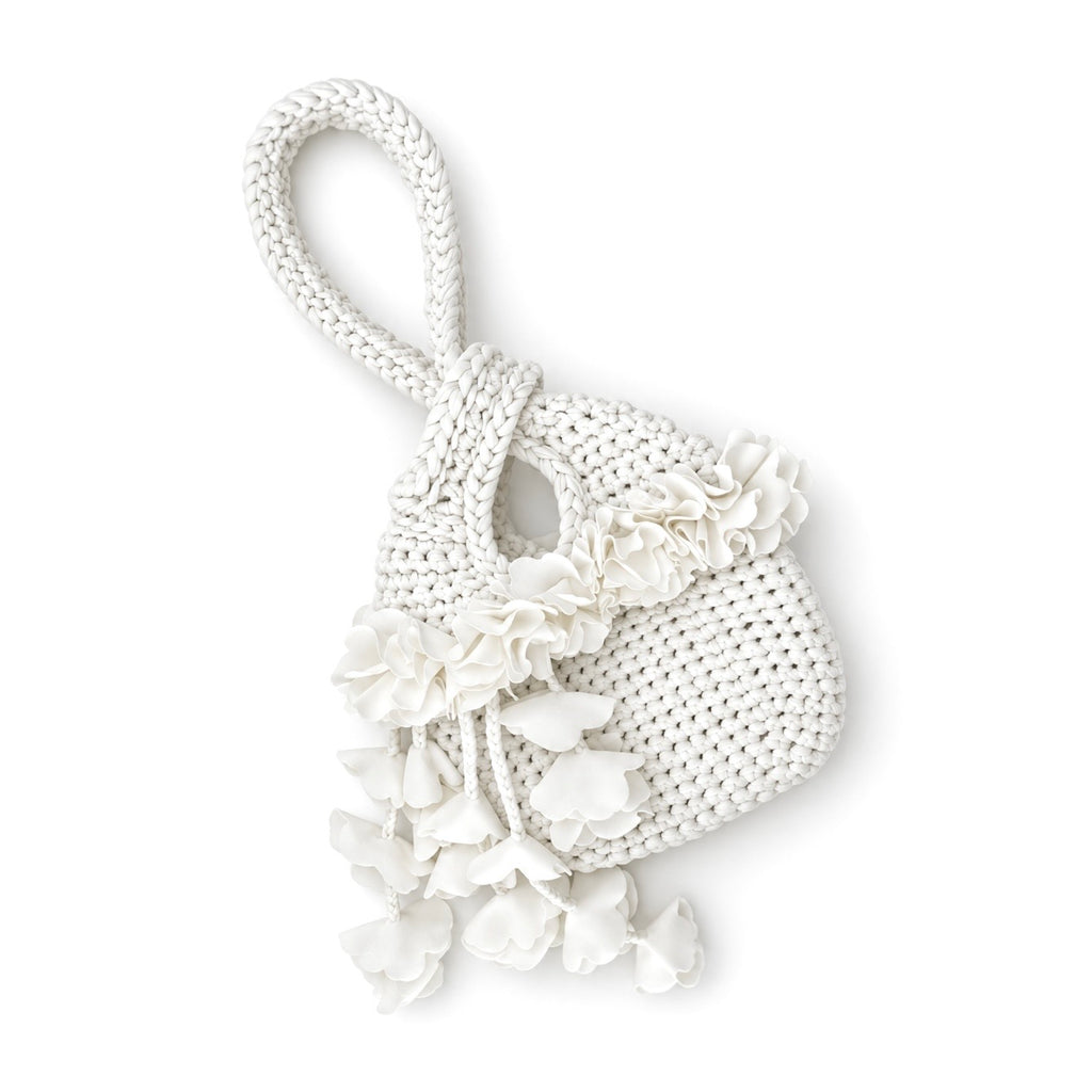 Handmade crochet petal bell mini swing bag in gardenia white with a loop through wristlet handle and cascading petal trim. 