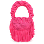 Hibiscus pink handmade crochet Cha Cha Mini bag featuring a crescent-shaped body, braided loop detailing, ruched scrunchie handle and flowing fringe. 
