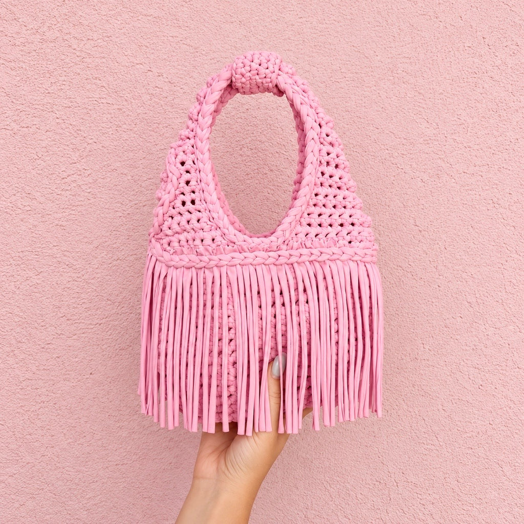 Handmade Petal pink crochet fringe mini bag with flowing fringe and a braided handle.