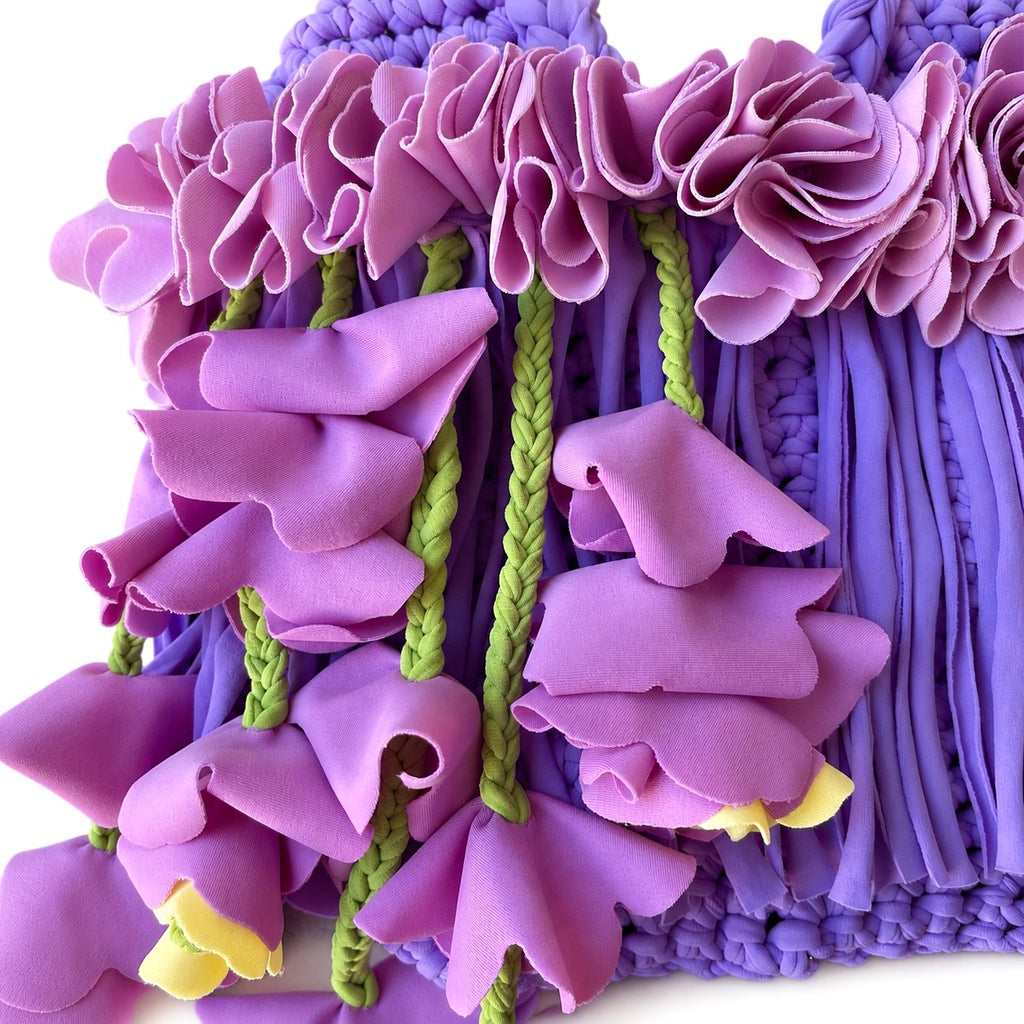 Handmade lilac purple crochet whimsy mini bag with cascading floral fringe and braided orchid petal bells.