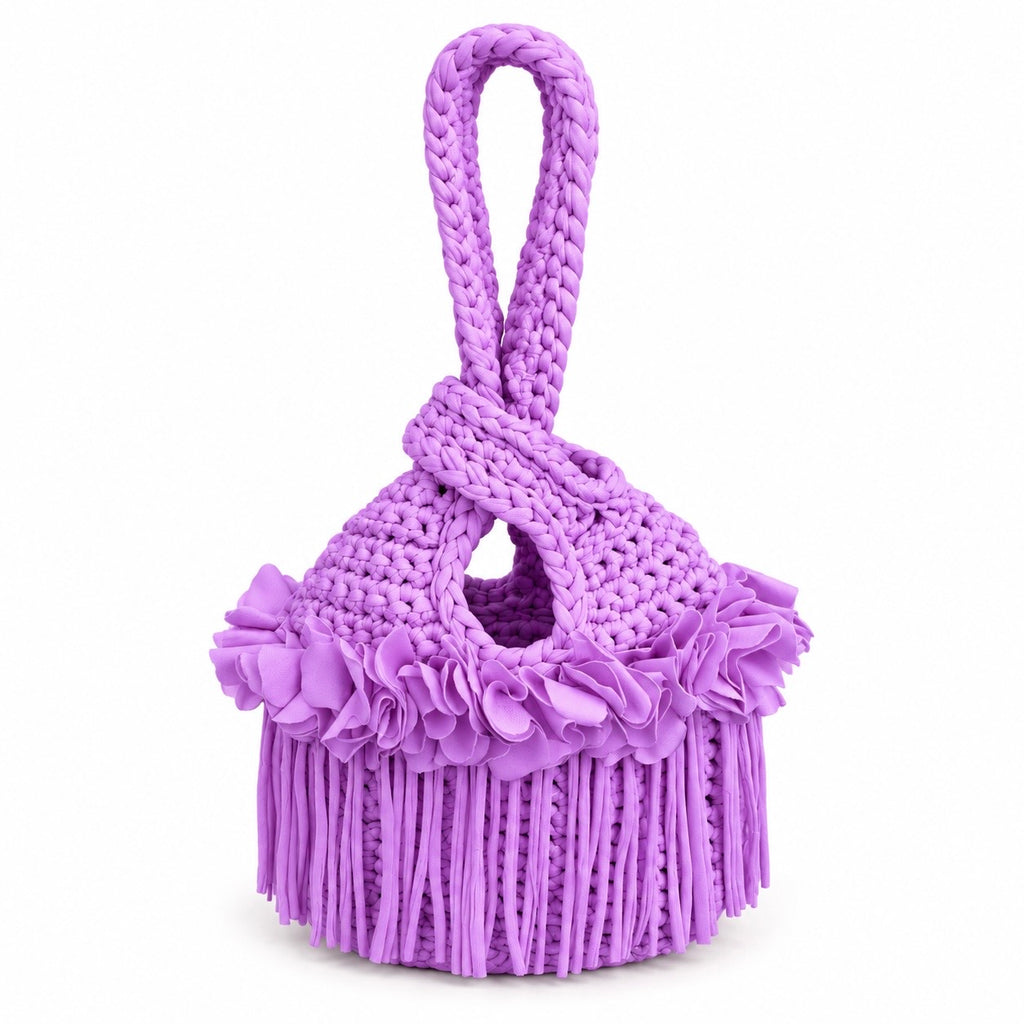 Handmade crochet mini swing bag in Orchid pink purple with flower fringe and a loop-through wristlet handle.