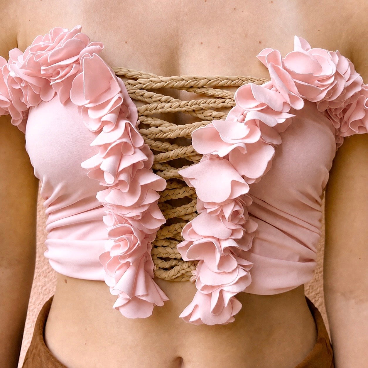 Petal pink floral tube top with flower lei trim and hand-crocheted, open lace-up center detail.