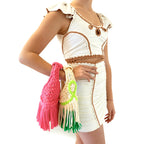 Handmade Hibiscus hot pink and Courtside white and green crochet fringe mini bags with flowing fringe and braided handles.