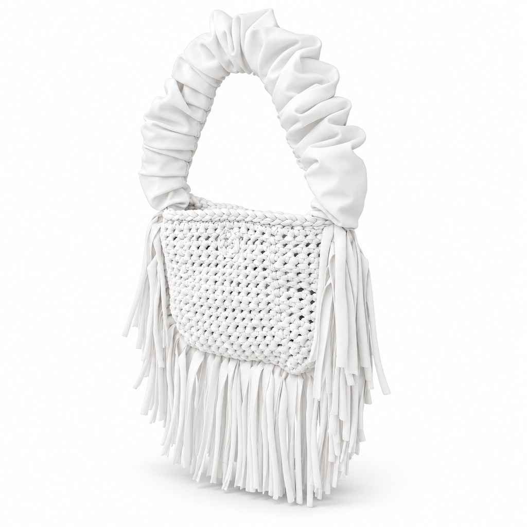 Gardenia white handmade crochet Cha Cha Mini bag featuring a crescent-shaped body, braided loop detailing, ruched scrunchie handle and flowing fringe. 
