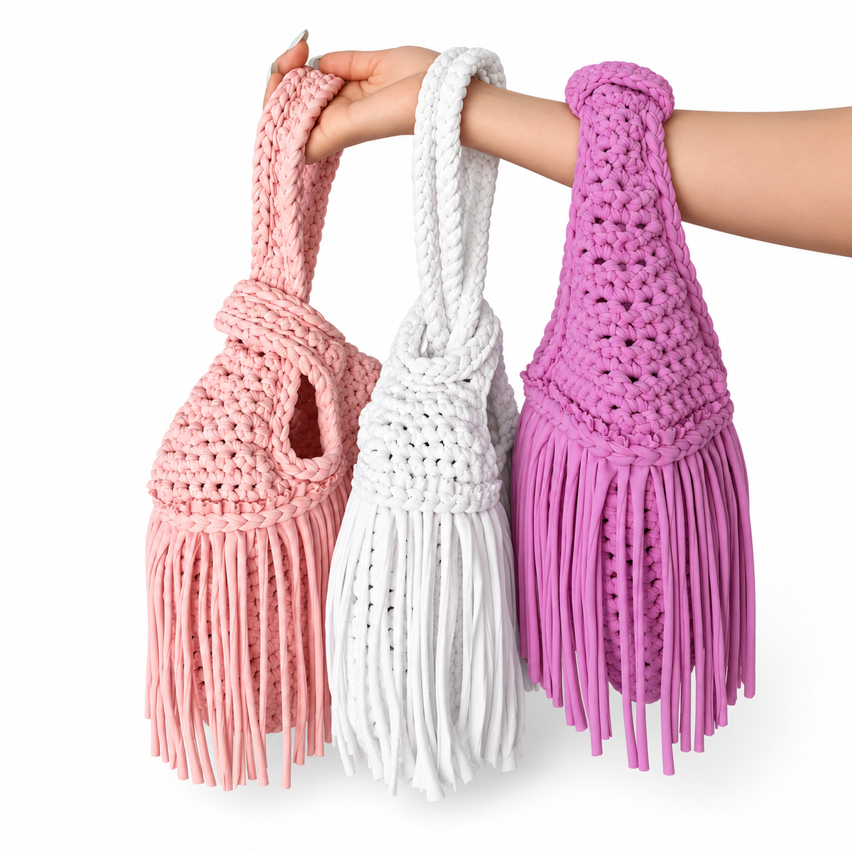 Handmade Mini Me crochet bag in pink, white and purple with braided wristlet handle and flowing fringe. Customize your colors and personalize with gold lettering.