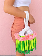 Handmade Gardenia white crochet mini swing bag with Petal pink flowers and neon yellow and green fringe with a loop-through wristlet handle.