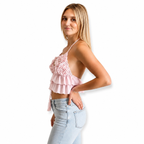 Petal pink floral rosette triangle tie halter top with hand-crocheted details and layered ruffles. 