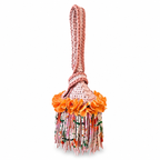 Handmade crochet mini swing bag in Desert Bloom tan with orange flower fringe and a loop-through wristlet handle.