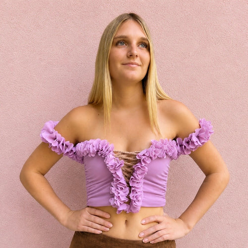Orchid purple pink floral off-the-shoulder crop top with flower lei trim and hand-crocheted lace-up center detail.