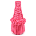 Handmade hot pink coral crochet mini bag with sculptural floral trim, flowing fringe and a braided handle.