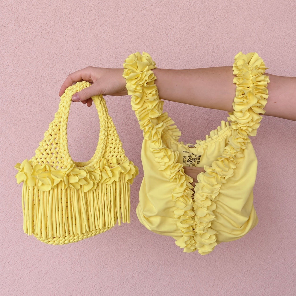 Handmade Daffodil yellow crochet top and mini bag with sculptural floral trim, flowing fringe and a braided handle.