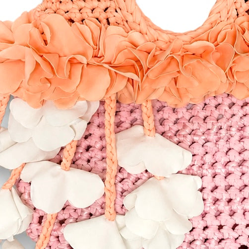 Handmade petal pink and poppy orange crochet floral mini bag with magnolia cream cascading petal bells. 