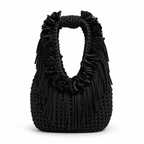 Onyx black hand-crocheted Flower Lei Mini bag with cascading floral ruffles and fringe, featuring a braided handle and sculptural mini silhouette.