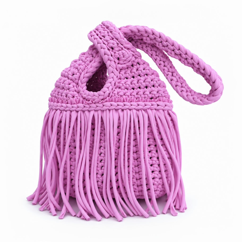 Handmade crochet mini swing bag in Orchid purple pink with flowing fringe and a loop-through wristlet handle.