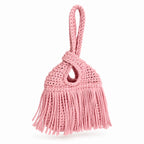 Handmade crochet mini swing bag in Petal pink with flowing fringe and a loop-through wristlet handle.