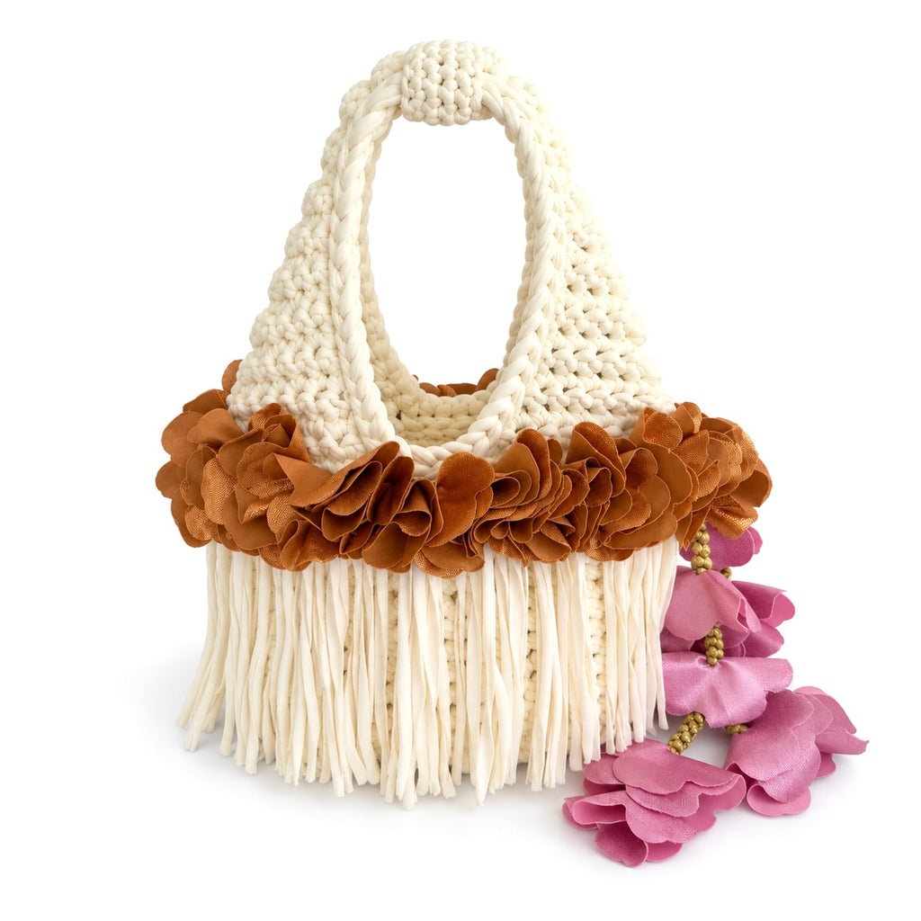Handmade magnolia cream crochet whimsy mini bag with cascading fringe, metallic pink and copper petal bell trim and a braided handle. 