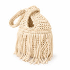 Handmade crochet mini swing bag in Magnolia cream with flowing fringe and a loop-through wristlet handle.