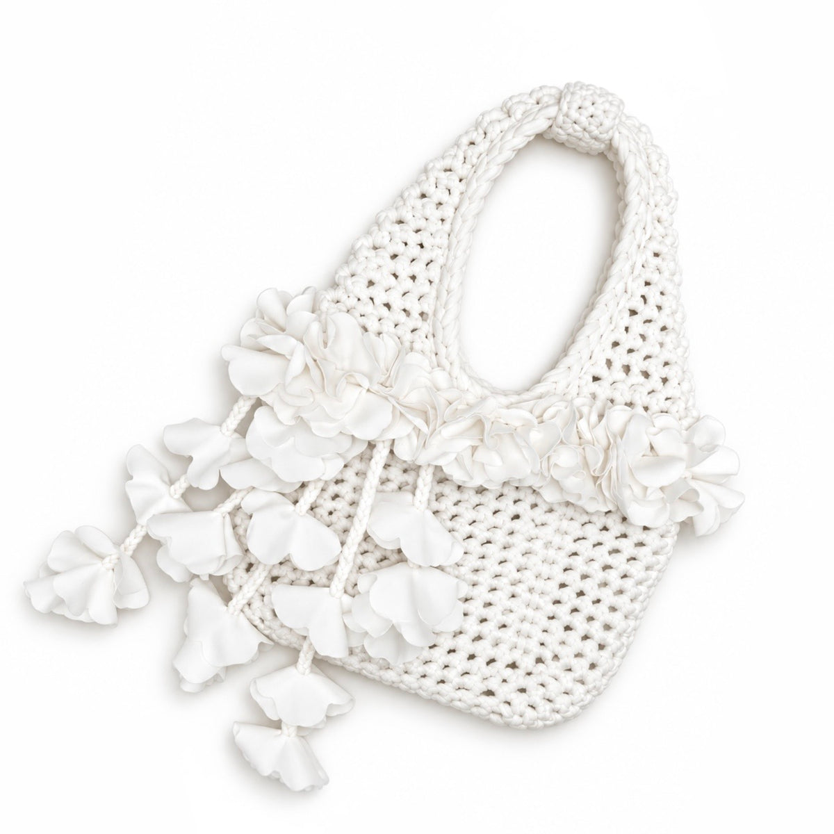 Handmade crochet petal bell mini bag in gardenia white, with braided handle and cascading petal trim. 
