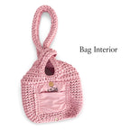 Handmade crochet mini swing bag in Petal pink with flowing fringe and a loop-through wristlet handle.