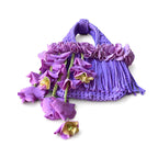 Handmade lilac purple crochet whimsy mini bag with cascading floral fringe and braided orchid petal bells.